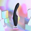 Playboy Overdrive Silicone Heating Vibrator Black displayed on a clear stand with colorful geometric shapes in the background.