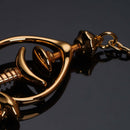 Close-up of elegant gold Pulling Chain Nipple Clamps featuring adjustable screws and curved design for comfort.