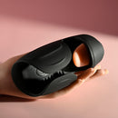 Evolved Lick the Tip Vibrating Tongue Stroker Black held in hand showing its design and texture.
