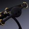 Black heart-shaped silicone mouth gag with gold hardware and Italian leather strap, emphasizing submission and comfort.