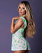 Woman wearing Reefer RN Cannabis Nurse Costume with neon green pot leaf print and white sheer stretch mesh from Exposed by Magic Silk.