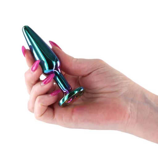 Rear Assets Chrome Tapered Anal Plug Medium held in hand with vibrant colors and stylish nails.