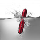Truly Yours Scarlet Velvet 10 Speed Bullet Vibrator splashing in water, showcasing its sleek design and waterproof feature.