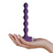 Petite Sensations Pearls Purple vibrating anal beads held in hand, showcasing its sleek silicone design and powerful functions.