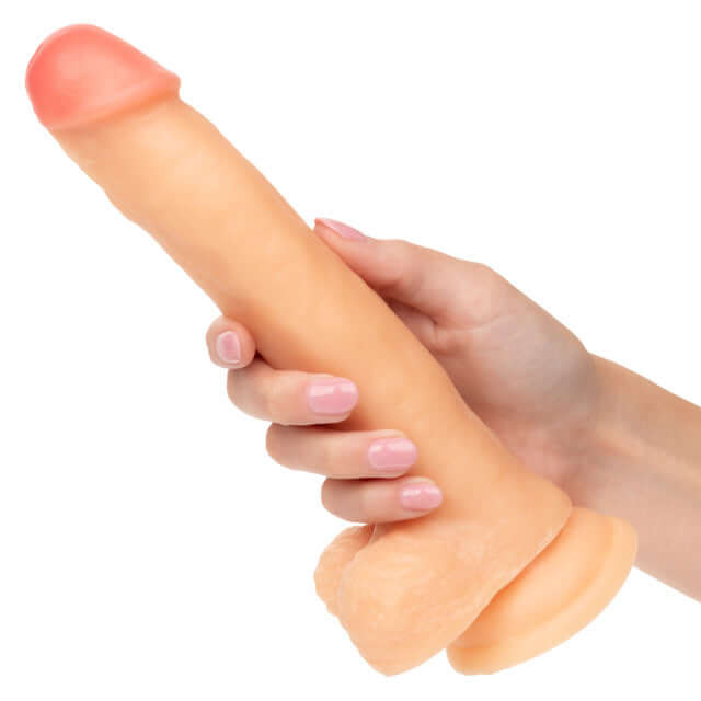 Life-like suction cup dildo "Working Stiff The Cabana Boy" held in hand, showcasing its realistic design for ultimate pleasure.