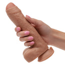 Hand holding the Working Stiff The Gyrating Bartender Rechargeable Dildo, showcasing its lifelike texture and design.