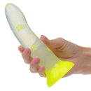 Glow Stick Star Silicone Glow-In-The-Dark Dildo Yellow held in hand, showcasing its bright color and star pattern.