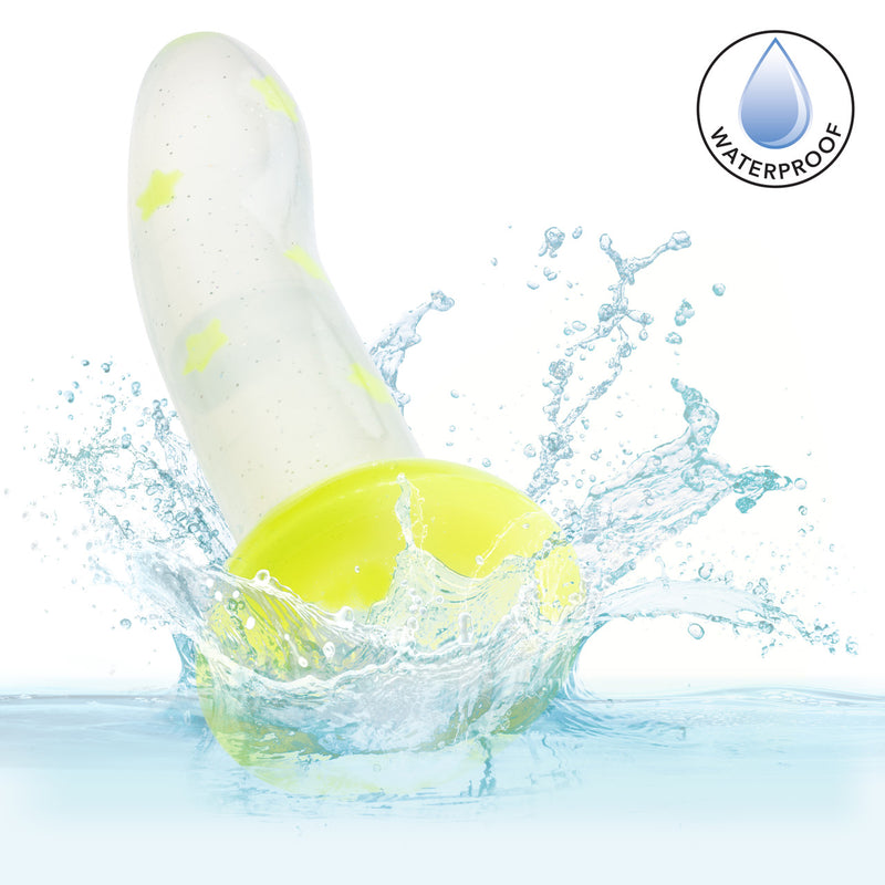 Glow Stick Star Silicone Glow-In-The-Dark Dildo Yellow splashing in water, showcasing waterproof feature.
