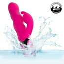 Enchanted Wave Action Bunny Rechargeable Vibrator Pink splashing in water, showcasing waterproof design and vibrant color.