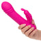 Hand holding Thicc™ Chubby Rotating Butterfly massager with thick shaft and butterfly teaser, made from premium liquid silicone.