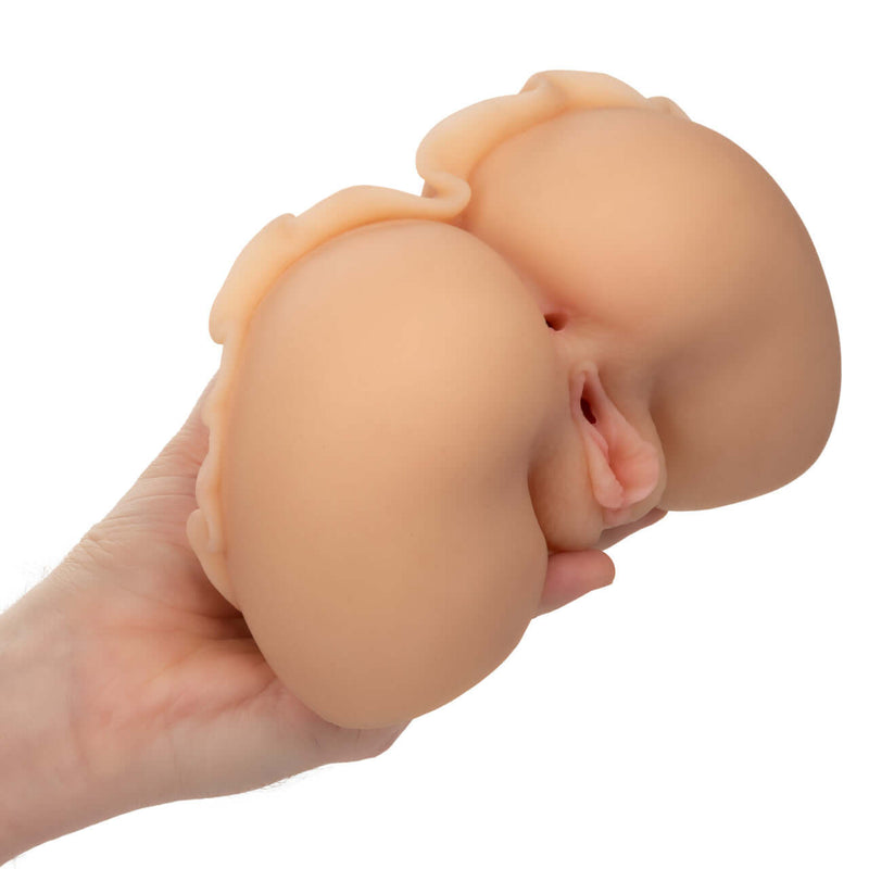 Person holding Cheap Thrills The Peep Show Girl ultra life-like Pure Skin masturbator with dual entry for an authentic experience.