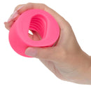 Glow-in-the-dark textured stroker held in hand showing ridged interior for enhanced oral play pleasure.