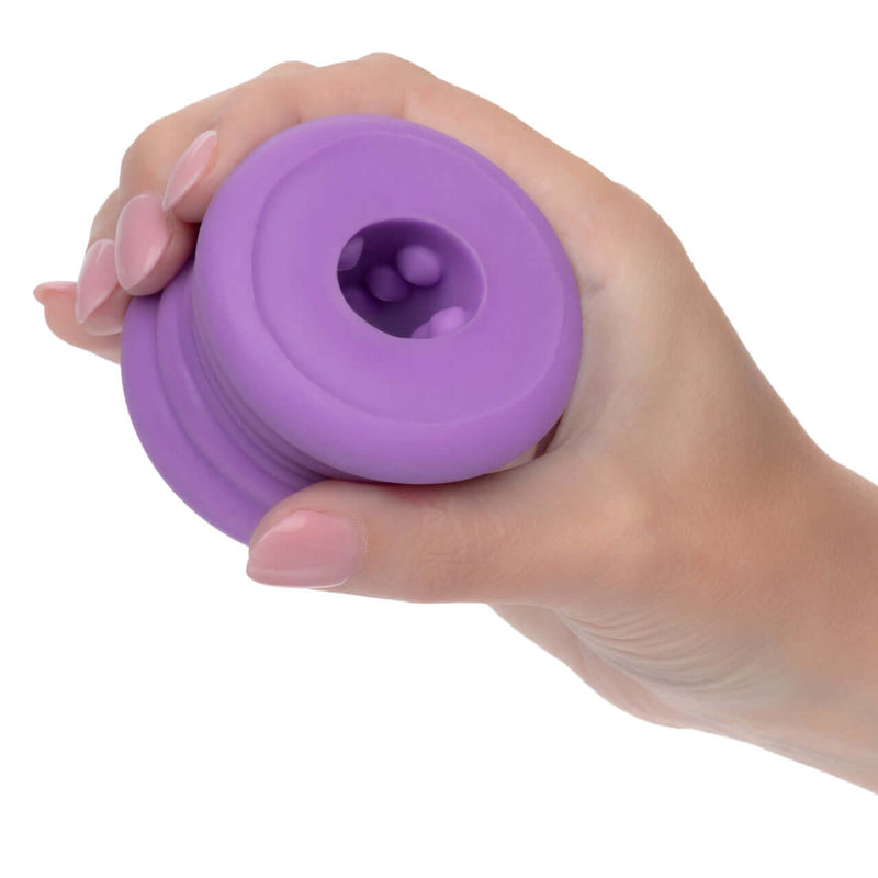Slop Top Dirty Luv glow-in-the-dark textured stroker in hand, showcasing its soft and smooth liquid silicone nubby texture for amplified pleasure.