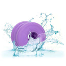 Glow-in-the-dark Slop Top Dirty Luv textured stroker in water splash displaying its waterproof feature and vibrant purple color.