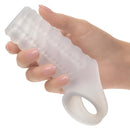 Hand holding Performance Maxx liquid silicone reversible sleeve with textured design and scrotum support.