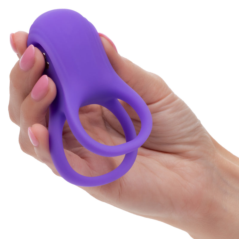 Basic Essentials Vibrating Dual Support Cock Ring Purple in a hand, showcasing its smooth silicone design and dual support features.