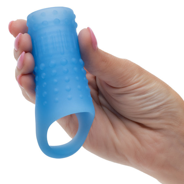 Hand holding the Basic Essentials Liquid Silicone Pleasure Enhancer Blue, showcasing its stretchy design and textured surface.