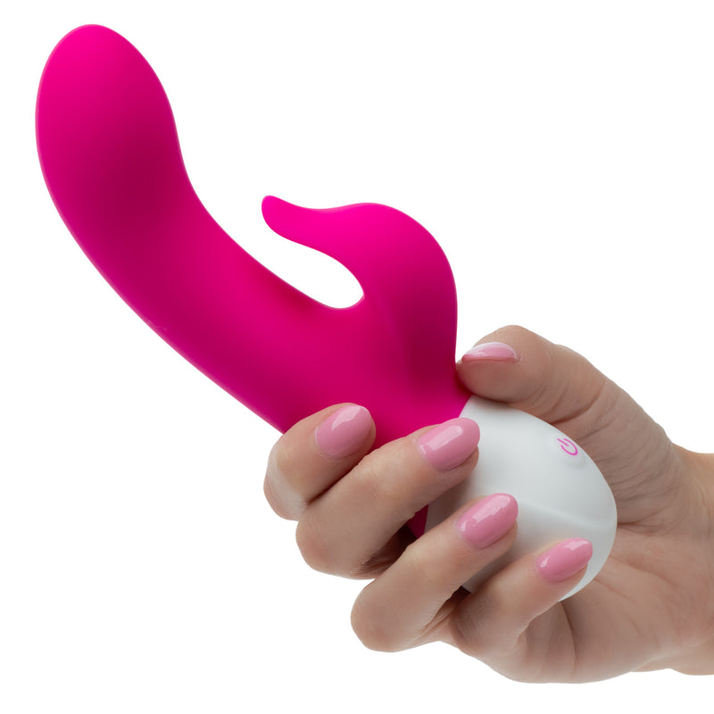 Basic Essentials Intense Power Rechargeable Dual Pleaser Pink held in hand to showcase its design and functionality.