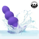 Basic Essentials Rechargeable Beaded Probe Purple splashing in water, showcasing waterproof design and beaded shaft.