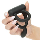 Closer Intimate Vibrating Dual Cock Ring Caress Black held in a hand, showcasing its dual-ring design and sleek black finish.