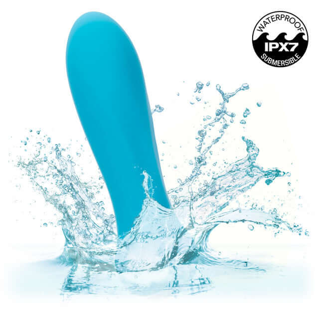 Blue Kyst Rocket mini bullet vibrator splashing in water, showcasing its waterproof IPX7 rating.