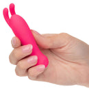 Person holding Kyst Bunny 10 Function Rechargeable Bullet Vibrator with bunny ears in vibrant pink color.