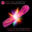 Endless Summer Sunset Seducer Light-up Massager Pink on a colorful background displaying its radiant LED feature.