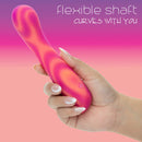 Hand holding the Endless Summer Sunset Seducer Light-up Massager Pink with a flexible shaft designed for customizable stimulation.