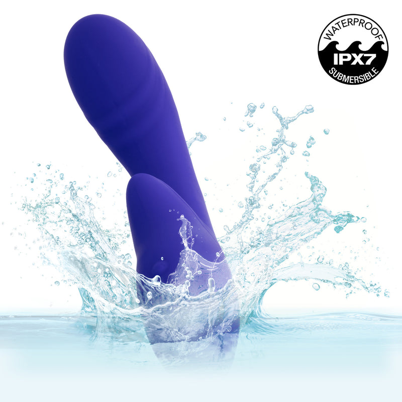 Rumbler Rumble G Rechargeable Silicone Dual Vibrator Purple splashing in water with waterproof IPX7 certification.