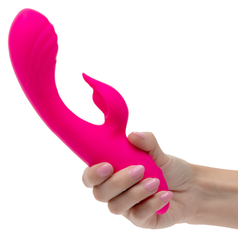 Rumbler Rumble Duo Silicone Rabbit Vibrator Pink being held, showcasing its design and vibrant color.
