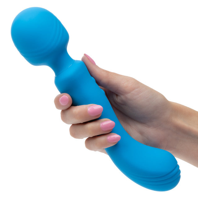 Rumbler Rumble Wand Rechargeable Silicone Vibrator Blue held in hand, showcasing its flexible design and smooth texture.