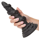 Hand holding Monster Dong The Kraken 8" liquid silicone suction cup dildo with intricate detailing