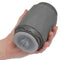 Hand holding the Milk Master Vibro Squeeze Pussy in gray, showcasing its ergonomic design and unique features.