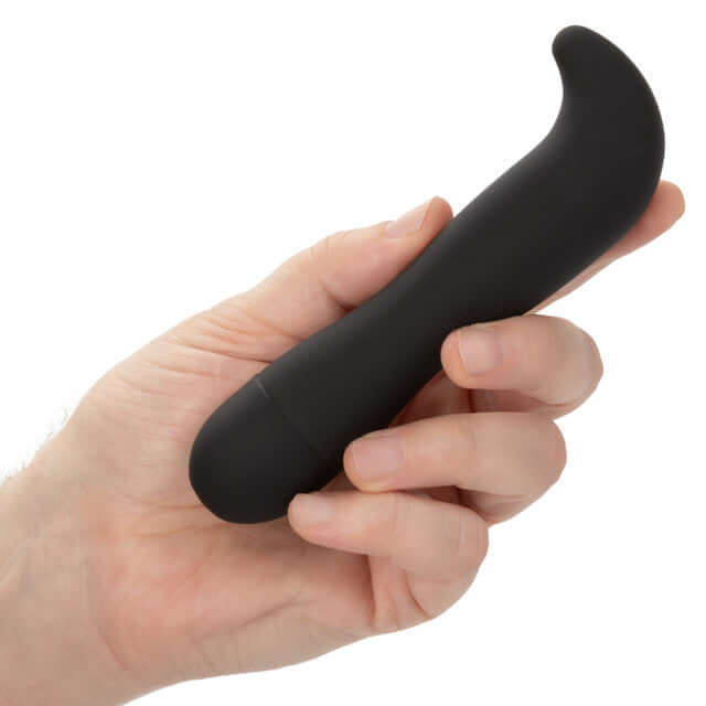 Hand holding Dr. Joel Kaplan Rechargeable Prostate Probe, a black ergonomically curved vibrator for targeted prostate stimulation.