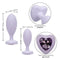 Two silicone anal plugs with heart crystal inlays, showcasing sizes and features for beginners in purple.