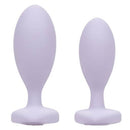First Time Crystal Booty Duo silicone anal plugs in purple, featuring graduated sizes and a smooth design.