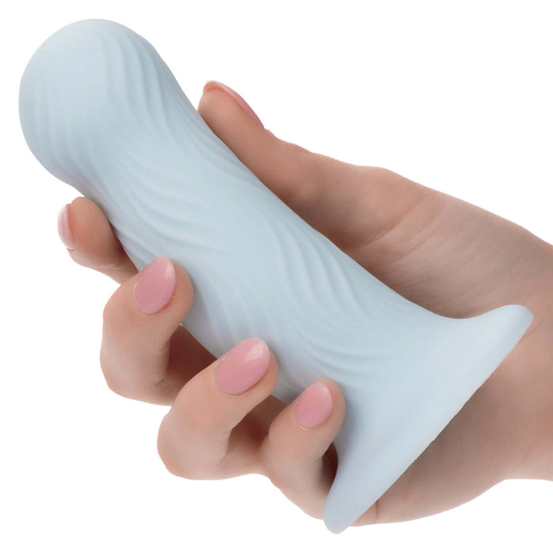 Hand holding the Wave Rider Foam Blue Probe highlighting its wavy texture and bulbous design for enhanced pleasure.