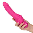 Power Stud Cliterrific Vibrator 6.75 inch Pink held in hand, showcasing its flexible and textured design.