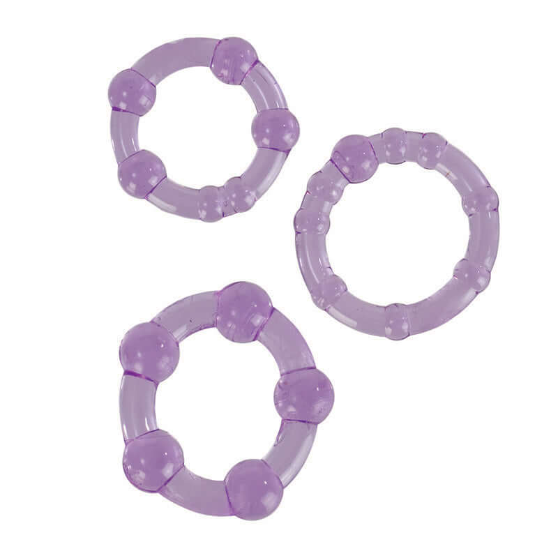 Trio of stretchy purple cock rings in small, medium, and large sizes by California Exotic Novelties for prolonged performance and heightened pleasure