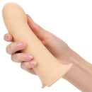 Performance Maxx Penis Extension With Harness Ivory being held in hand for intimate play enhancements.