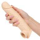 Performance Maxx Life Like Penis Extension 8 inches with hollow design and scrotum strap held in a hand