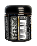 Sensuva Lit Champagne Luxury Massage Candle 4 oz jar with ingredients and label details on back.