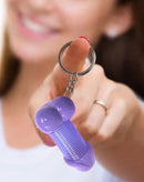 Super Fun Key Chain Penis Slinky held by a woman, showcasing its playful design and fun colors.