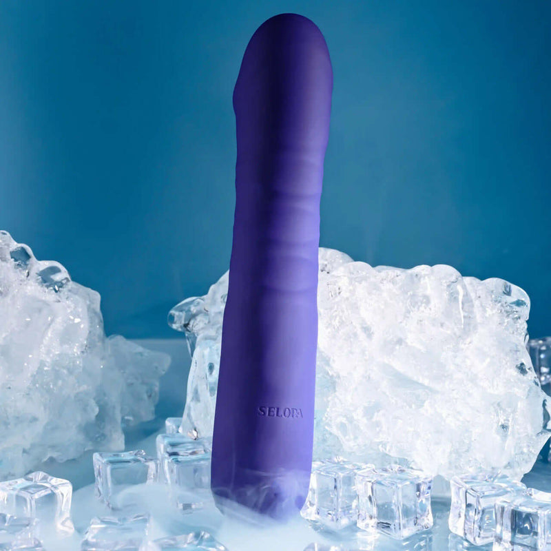 Ambition purple thrusting vibrator with phallic shape surrounded by ice cubes, showcasing 10 speeds and patterns for lifelike stimulation.