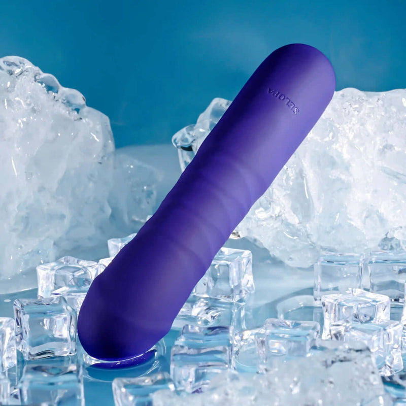 Purple thrusting vibrator with phallic shape, showcased on ice cubes, featuring 10 speeds and patterns for dynamic stimulation.