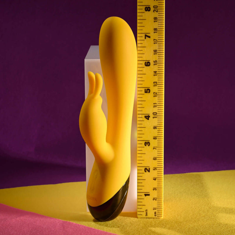 Selopa Buzzz Bunny rechargeable silicone rabbit vibrator in yellow, showcasing its flexible design and size measurement.