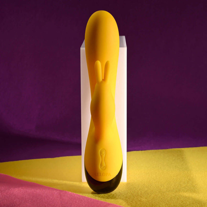 Selopa Buzzz Bunny rechargeable silicone rabbit vibrator in yellow with bunny ears and flexible design.