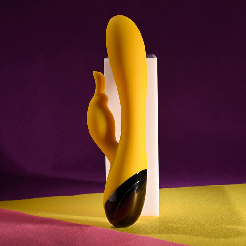Yellow rechargeable silicone rabbit vibrator with dual motors, featuring a sleek design and bunny stimulator.