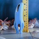 Selopa Tentacle Tickler, a blue silicone clitoral stimulator with tentacles, measuring 5.38 inches tall, on a wooden surface.