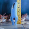 Selopa Tentacle Tickler, a blue silicone clitoral stimulator with tentacles, measuring 5.38 inches tall, on a wooden surface.